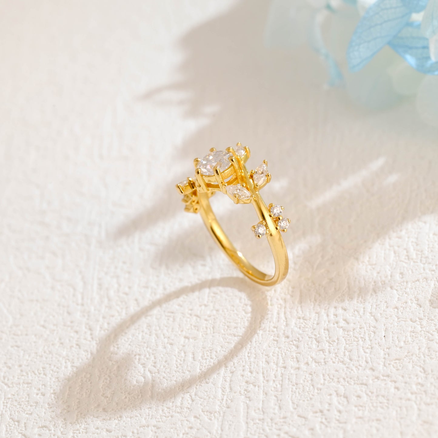 solid-gold-round-cut-moissanite-engagement-ring-side-stone-marquise-cut-ring-leaf-ring