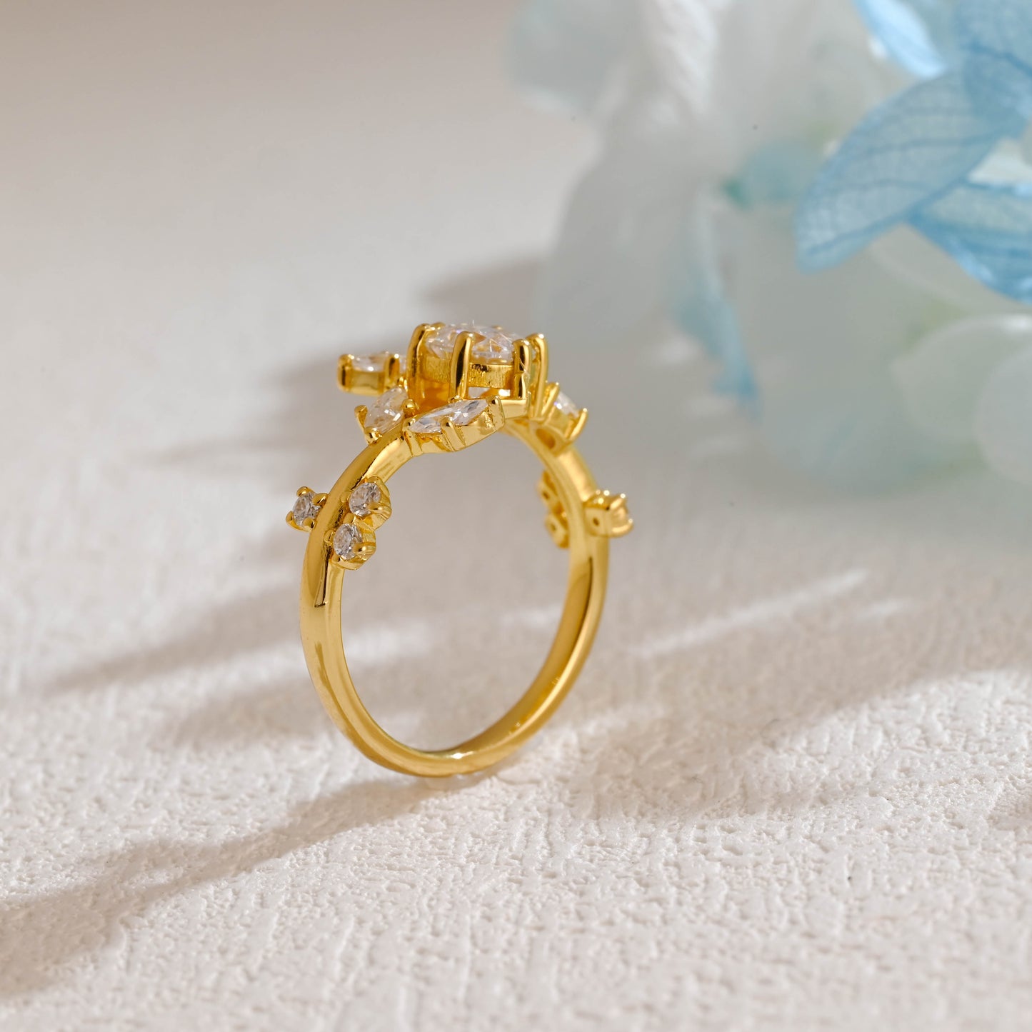 solid-gold-round-cut-moissanite-engagement-ring-side-stone-marquise-cut-ring-leaf-ring