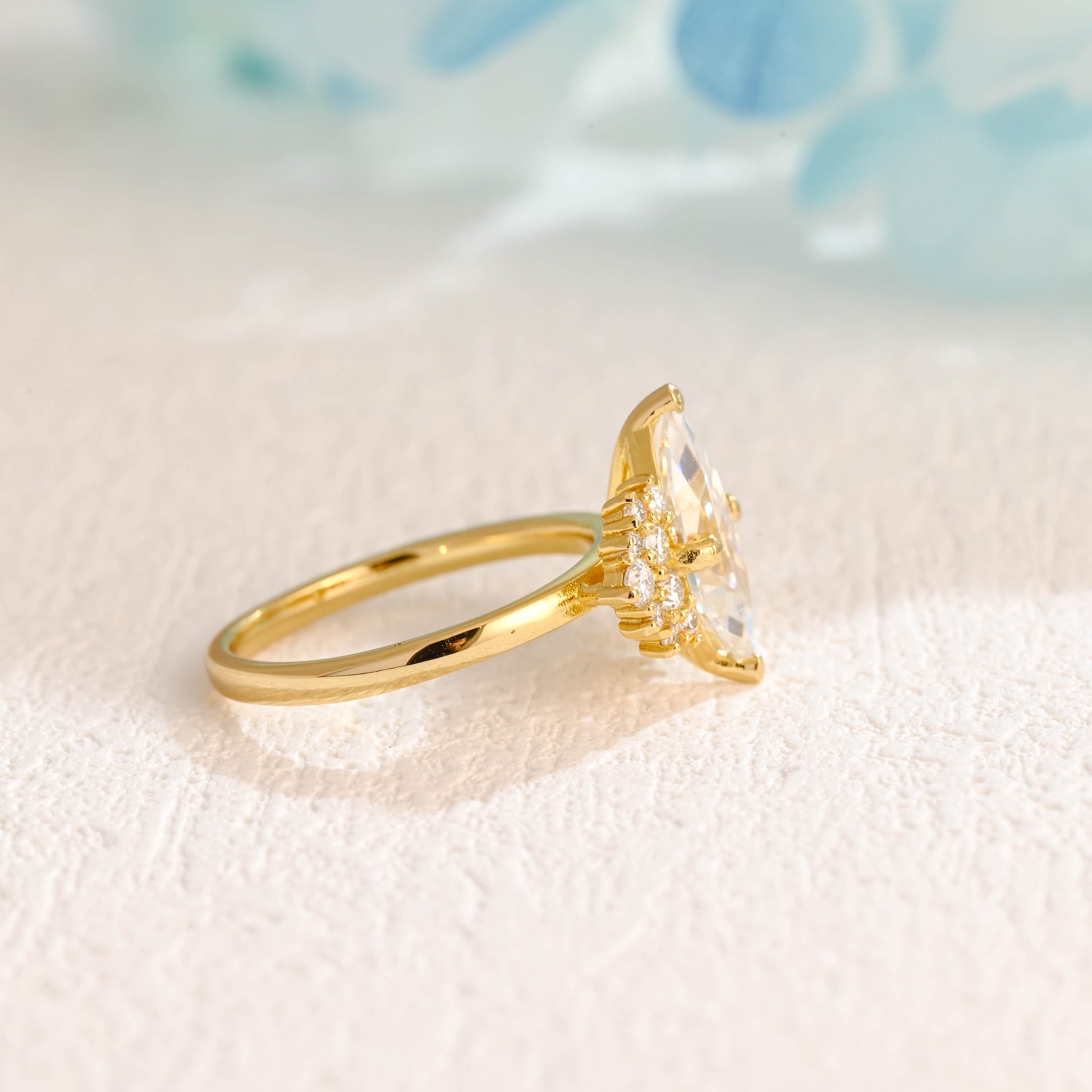 solid-gold-marquise-cut-moissanite-engagement-ring-side-stone-round-ring-cluster-ring