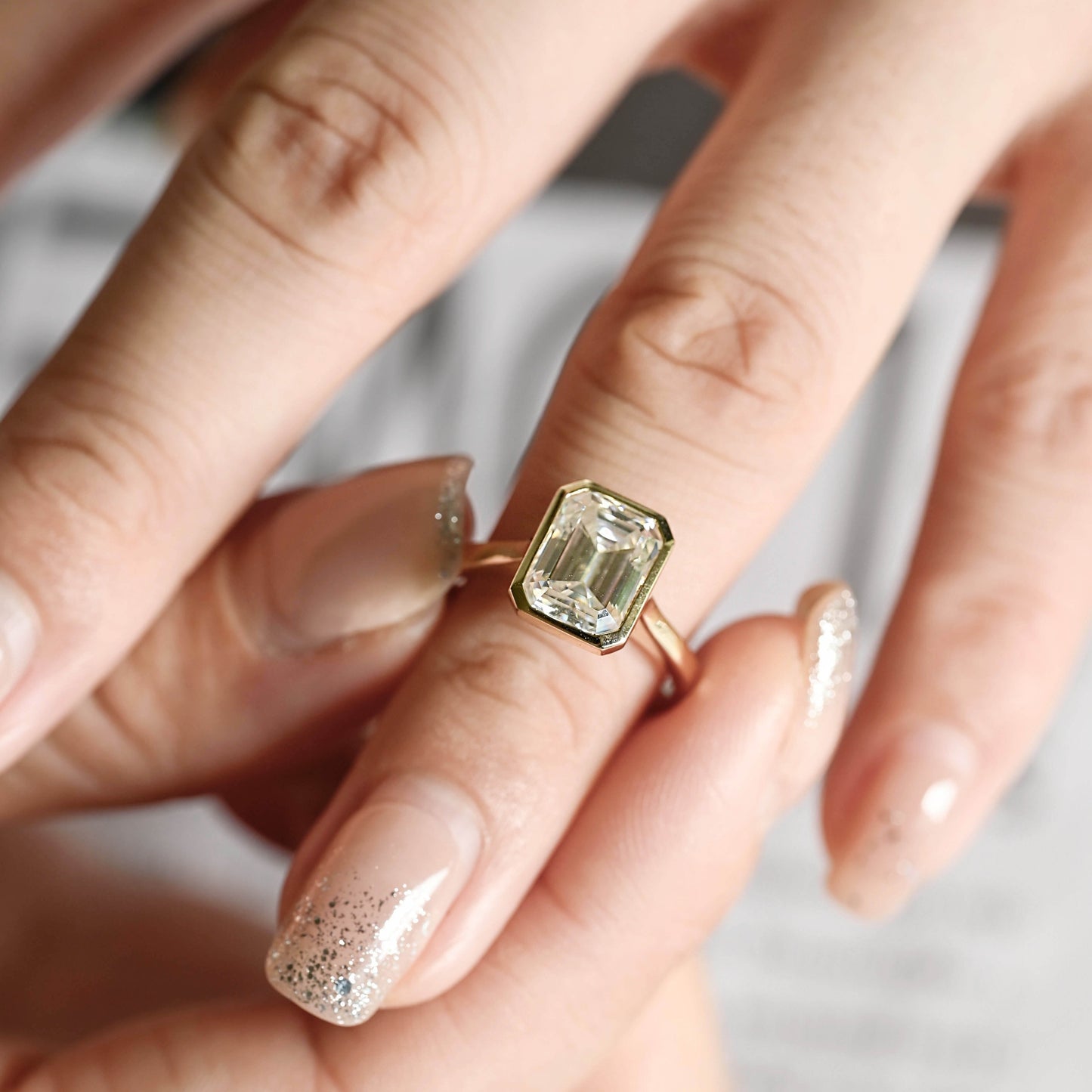 solid-gold-emerald-cut-diamond-ring-bezel-ring-cathedral-setting