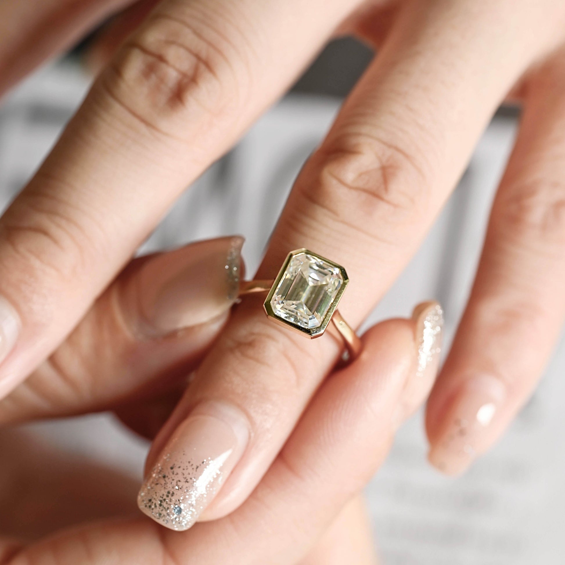 solid-gold-emerald-cut-diamond-ring-bezel-ring-cathedral-setting