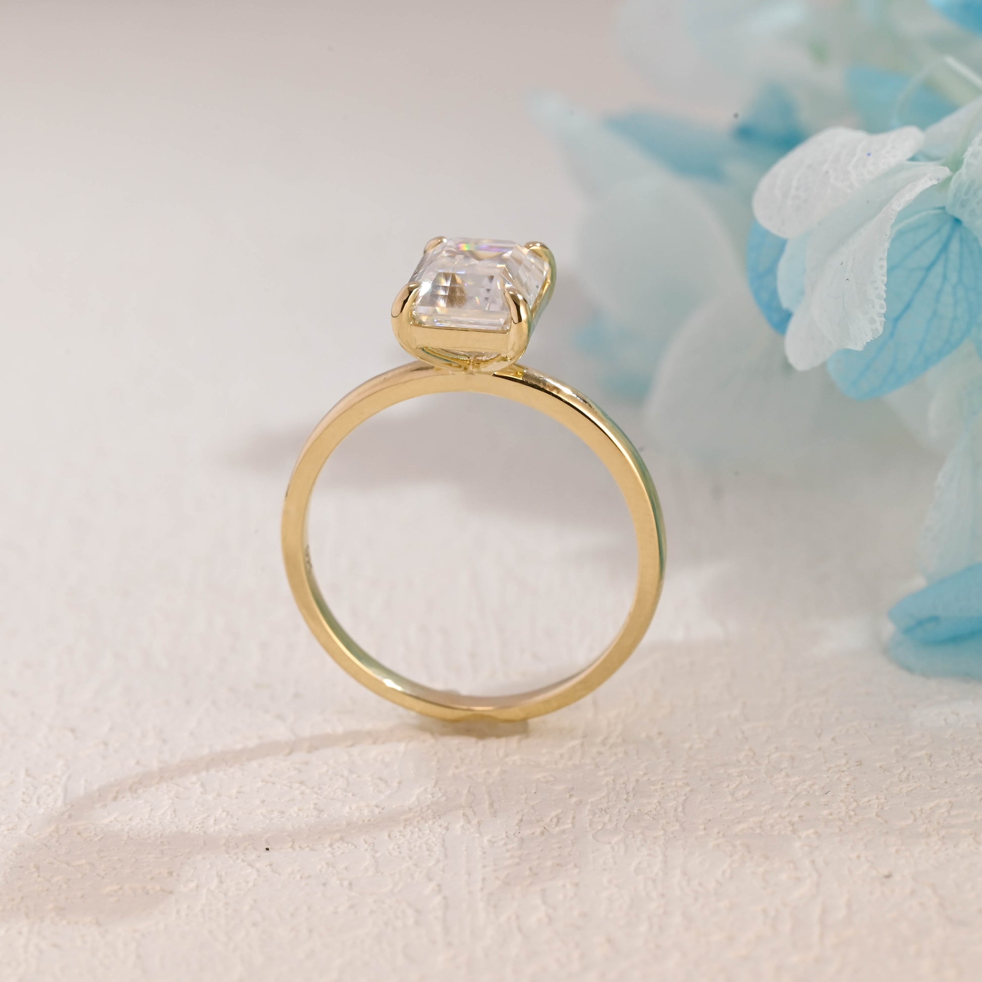 solid-gold-solitaire-emerald-cut-moissanite-engagement-ring