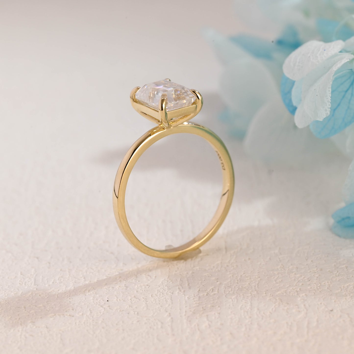 solid-gold-solitaire-emerald-cut-moissanite-engagement-ring