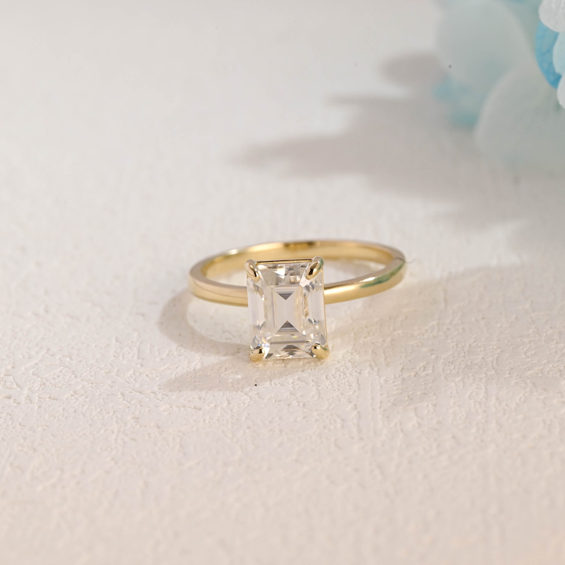 solid-gold-solitaire-emerald-cut-moissanite-engagement-ring