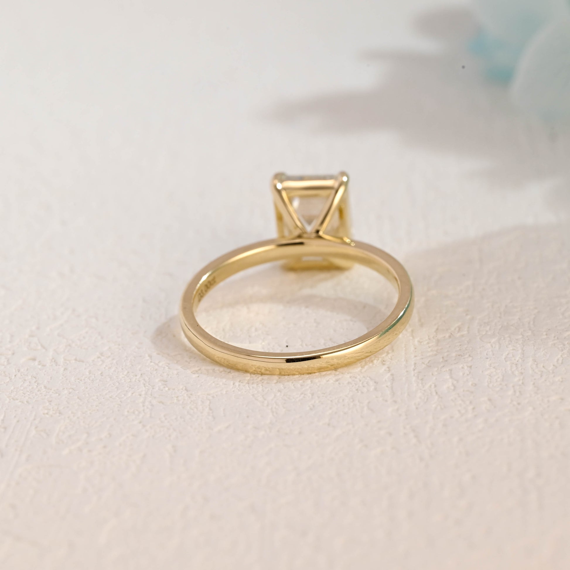 solid-gold-solitaire-emerald-cut-moissanite-engagement-ring