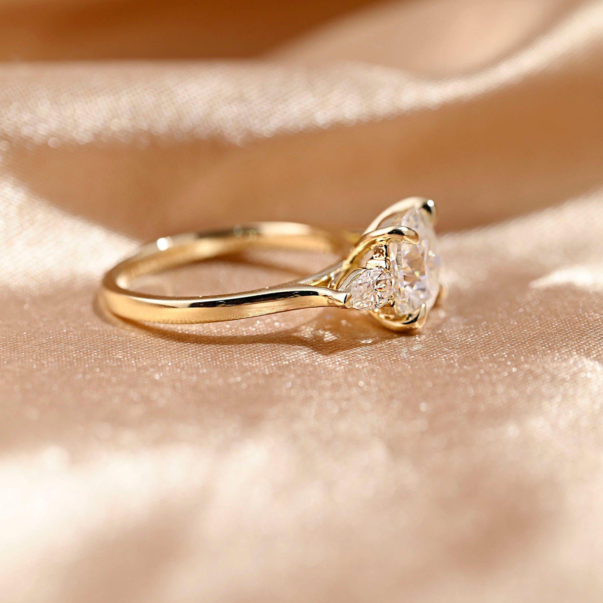 solid-gold-cushion-cut-moissanite-engagement-ring-three-stone-ring-pear-cut-ring