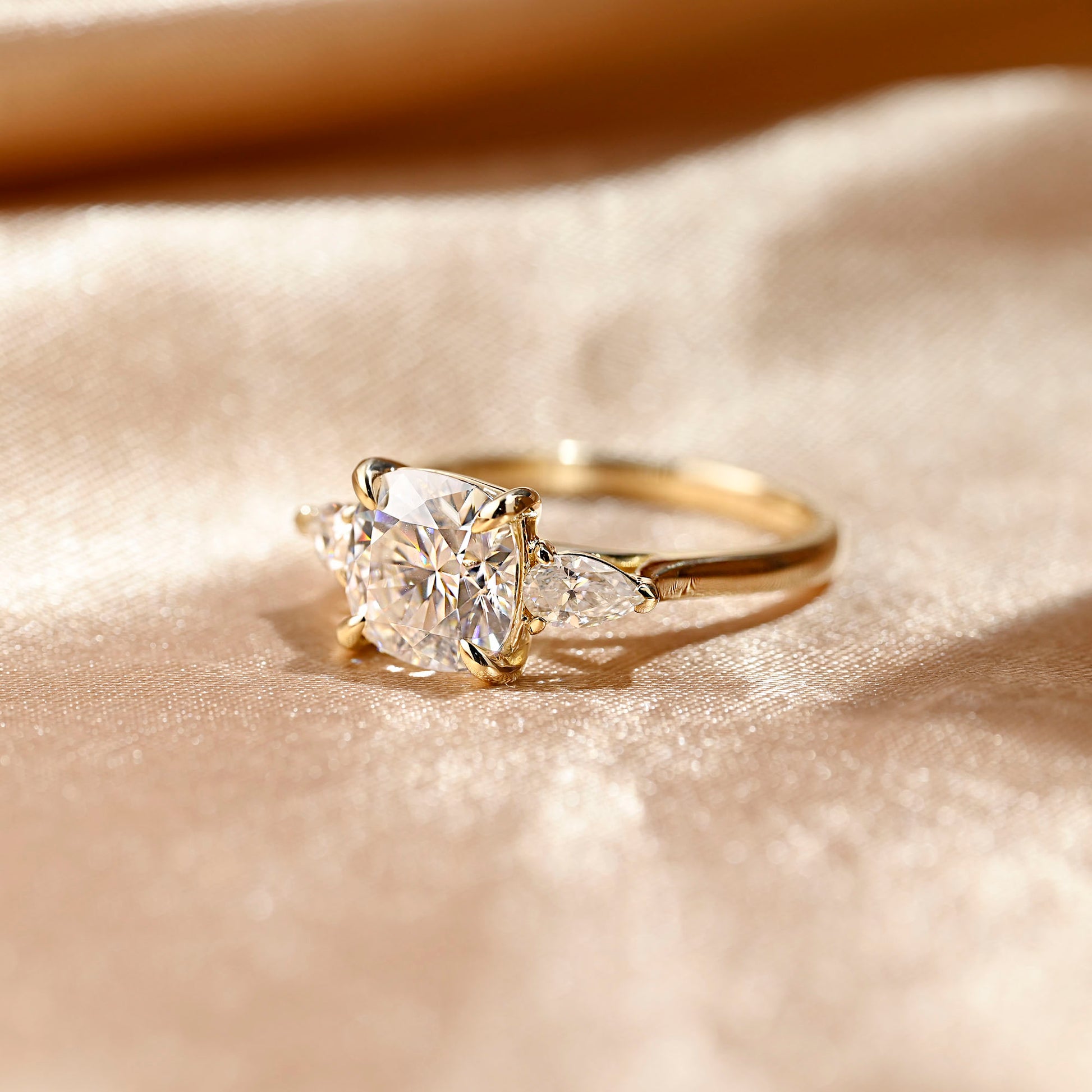 solid-gold-cushion-cut-moissanite-engagement-ring-three-stone-ring-pear-cut-ring