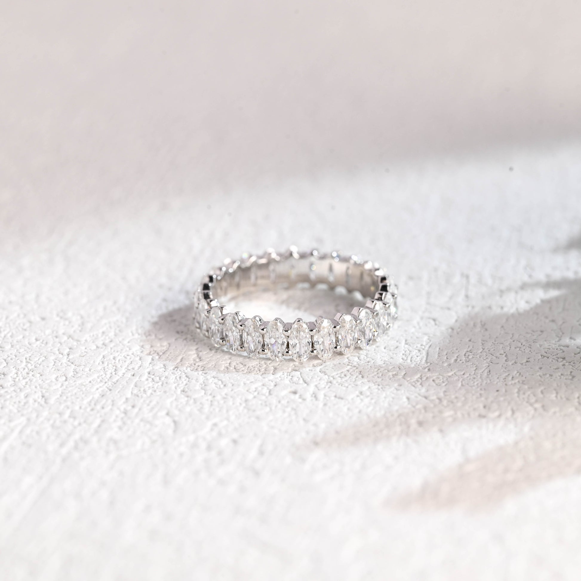 crushed-ice-cut-moissanite-wedding-band-oval-eternity-band