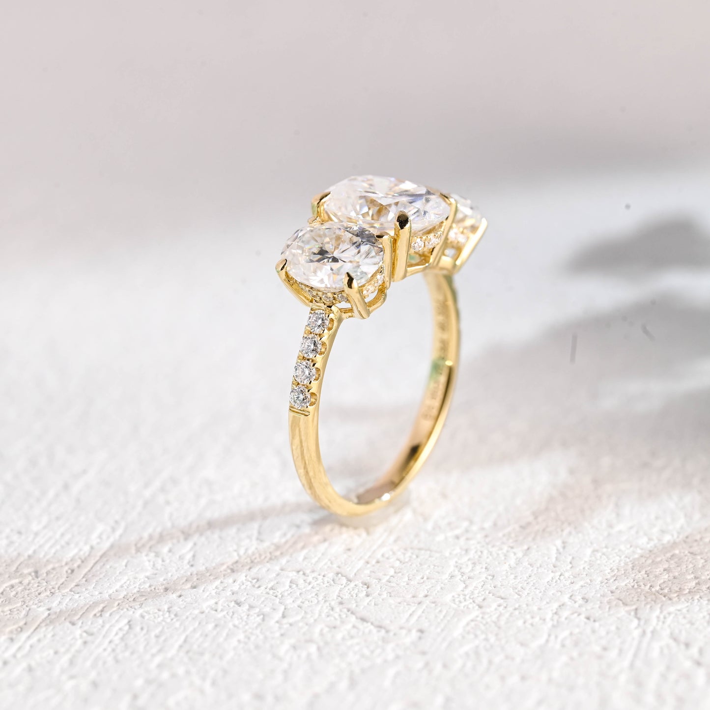 oval-cut-three-stone-engagement-ring-hidden-halo-half-pave-ring