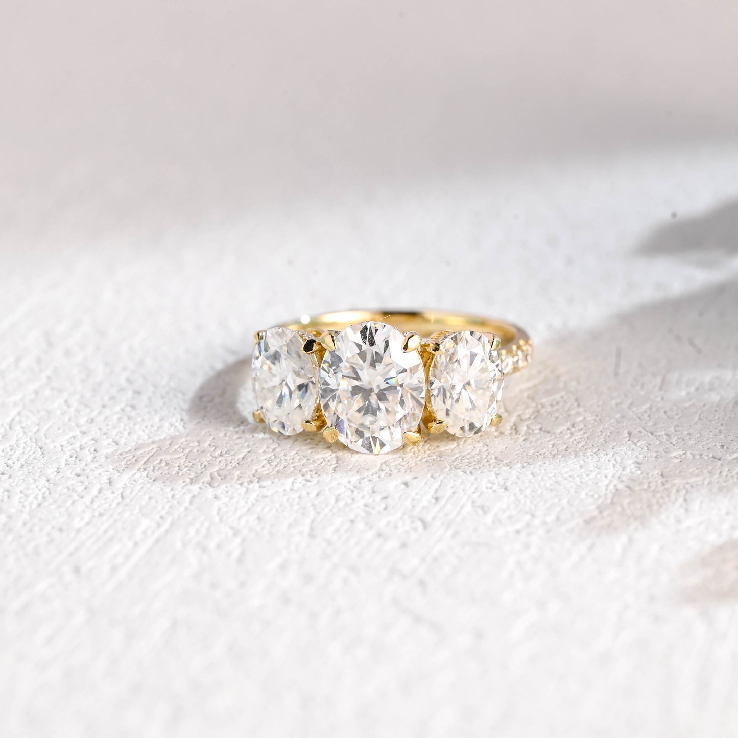 oval-cut-three-stone-engagement-ring-hidden-halo-half-pave-ring